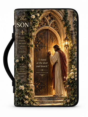 A Bible or book cover with a black handle, featuring a printed illustration of Jesus standing before a glowing stone door, with floral vines and the text 'The SON' and a Bible verse on the cover.