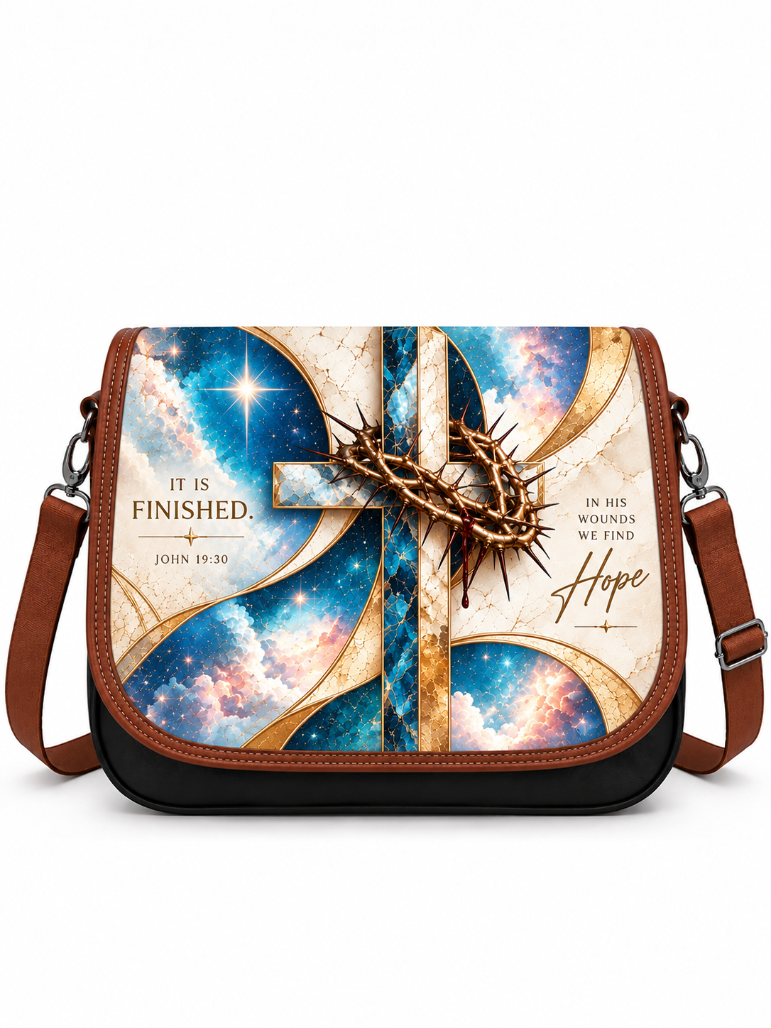 A messenger-style shoulder bag with a brown leather trim and strap, featuring a printed graphic of a gold cross over a blue and cream galaxy background with inspirational religious text and a crown of thorns ornament.