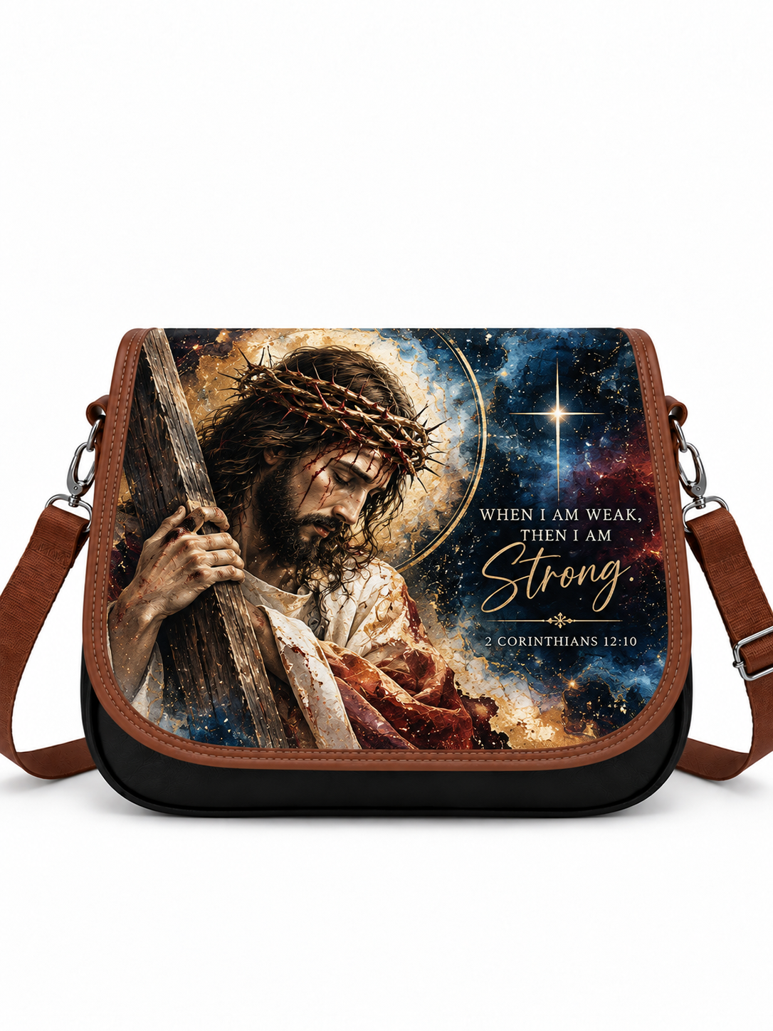 A messenger-style shoulder bag with a brown leather trim and a large printed graphic on the front showing Jesus carrying a cross against a starry night sky. The text on the print reads, 'WHEN I AM WEAK, THEN I AM Strong' and 'CORINTHIANS 12:10'.