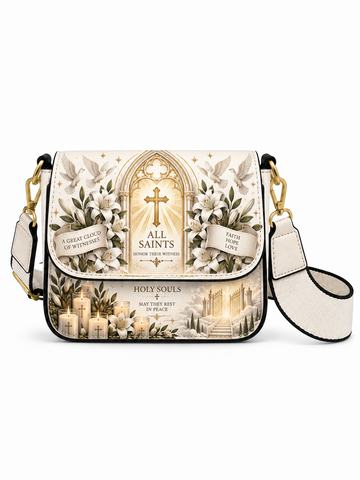 A small shoulder bag with a religious gothic design, featuring a cream and gold 'All Saints' theme with a cross, candles, and white lilies. The bag has black trim, gold-tone hardware, and a matching cream webbed shoulder strap.
