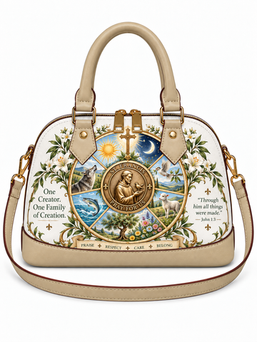 A beige dome-shaped handbag with a detailed religious illustration featuring Saint Joseph, a cross, a crescent moon, and the words 'One Creator, One Family of Creation' on a white background.