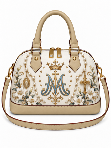 A structured dome handbag in beige faux leather with gold-tone hardware, featuring an intricate embroidered design on the front. The embroidery includes a large blue and gold monogram 'M' under a crown, surrounded by white flowers, green leaves, and pearl-like bead details.