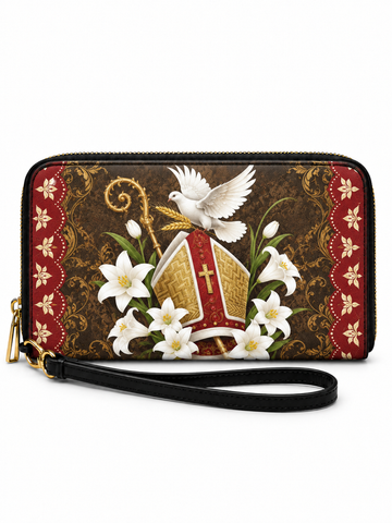 A rectangular zip-around wristlet clutch with a black wrist strap, featuring a religious design of a red and gold bishop's mitre, white lilies, a white dove, and a golden crozier on a dark brown damask background, with red patterned side borders.