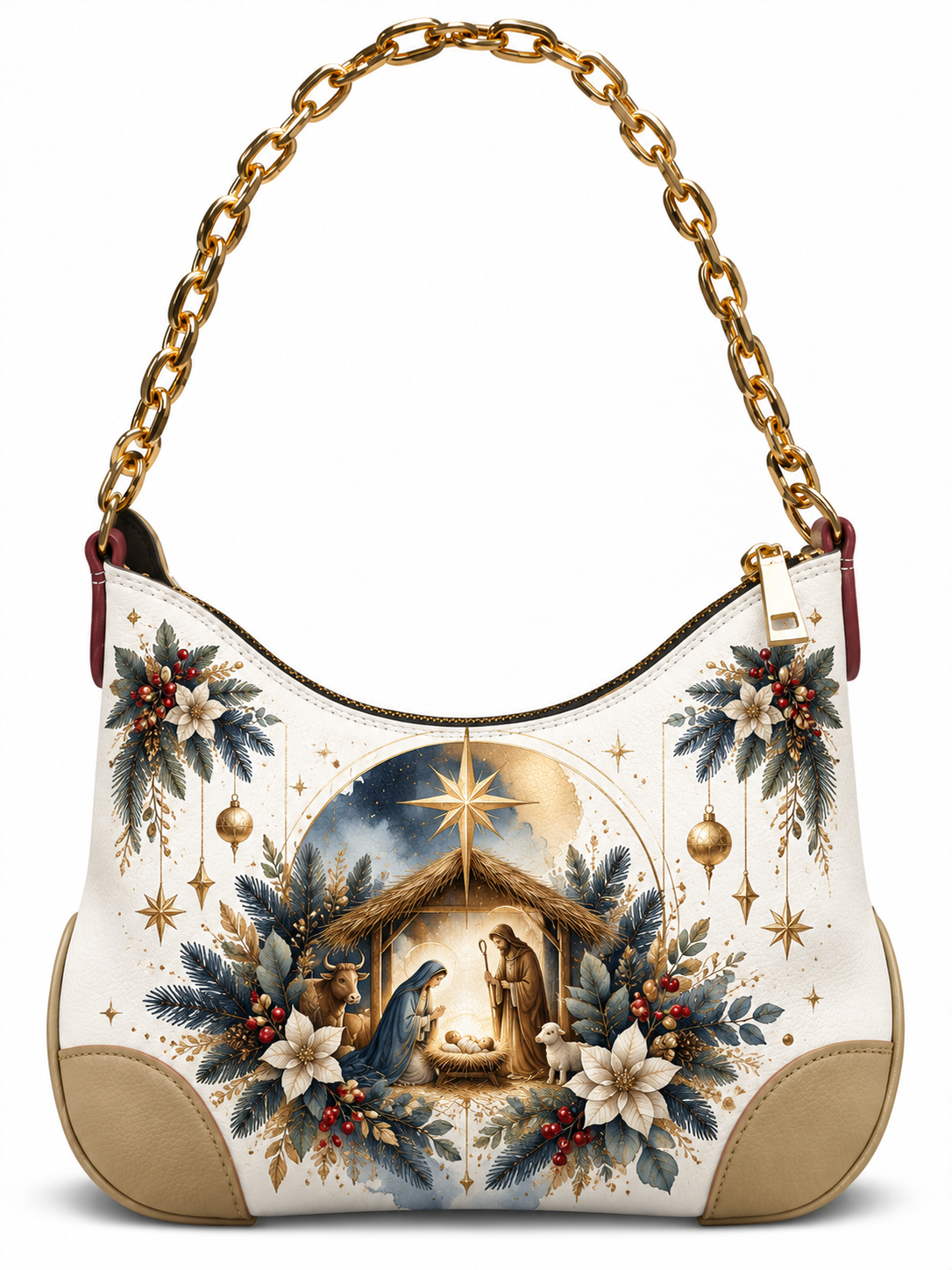 A hobo-style shoulder bag with a gold chain strap, cream and tan leather base, and a detailed Christmas Nativity illustration featuring blue foliage, white flowers, red berries, and a golden starry sky.