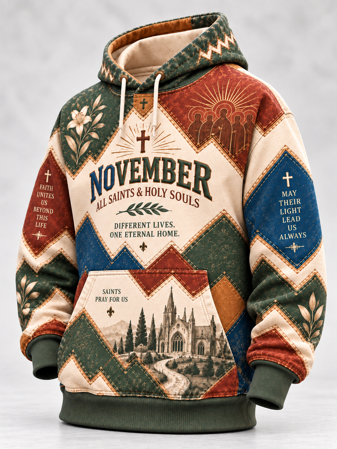 A hooded sweatshirt with a patchwork design featuring religious motifs, including 'November All Saints & Holy Souls' text, church illustrations, and geometric patterns in beige, green, blue, and brown tones.