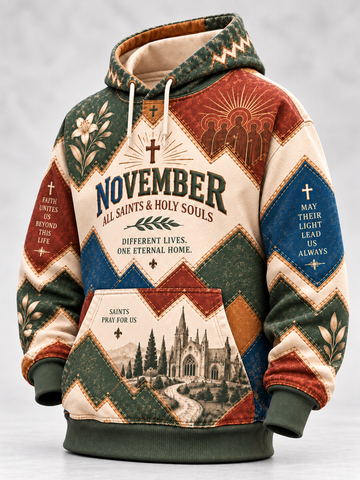 A hooded sweatshirt with a patchwork design featuring religious motifs, including 'November All Saints & Holy Souls' text, church illustrations, and geometric patterns in beige, green, blue, and brown tones.