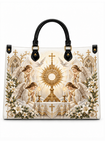 A structured tote bag with black leather handles and gold-tone hardware, featuring a large religious print of the Eucharist with angels, candles, lilies, and a radiant chalice on a white background.