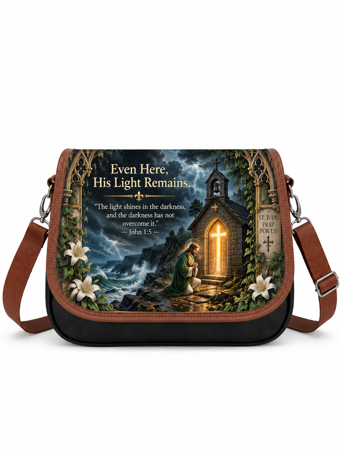 A black messenger bag with brown leather straps and trim, featuring a detailed religious graphic print of a church in a dark forest with a glowing cross and the text 'Even Here, His Light Remains' and a Bible verse.