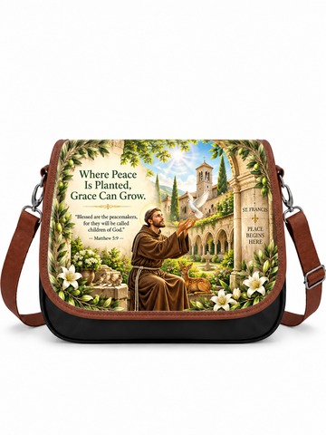 A black and brown crossbody bag with a detailed religious illustration of St. Francis on the front flap, featuring the text 'Where Peace Is Planted, Grace Can Grow' and a white background.