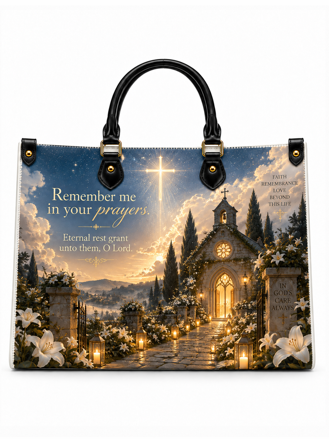 A structured tote bag with black handles and gold-tone hardware, featuring a printed scenic design of a church pathway at sunset with flowers, candles, and the text 'Remember me in your prayers, Eternal rest grant unto them, O Lord.'.