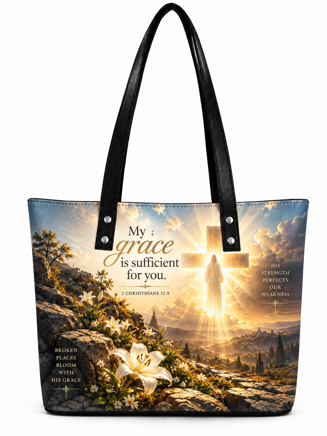 A tote bag with black handles, featuring a printed religious design of a glowing cross, a figure in prayer, white lilies, and Bible verse text on a white background.