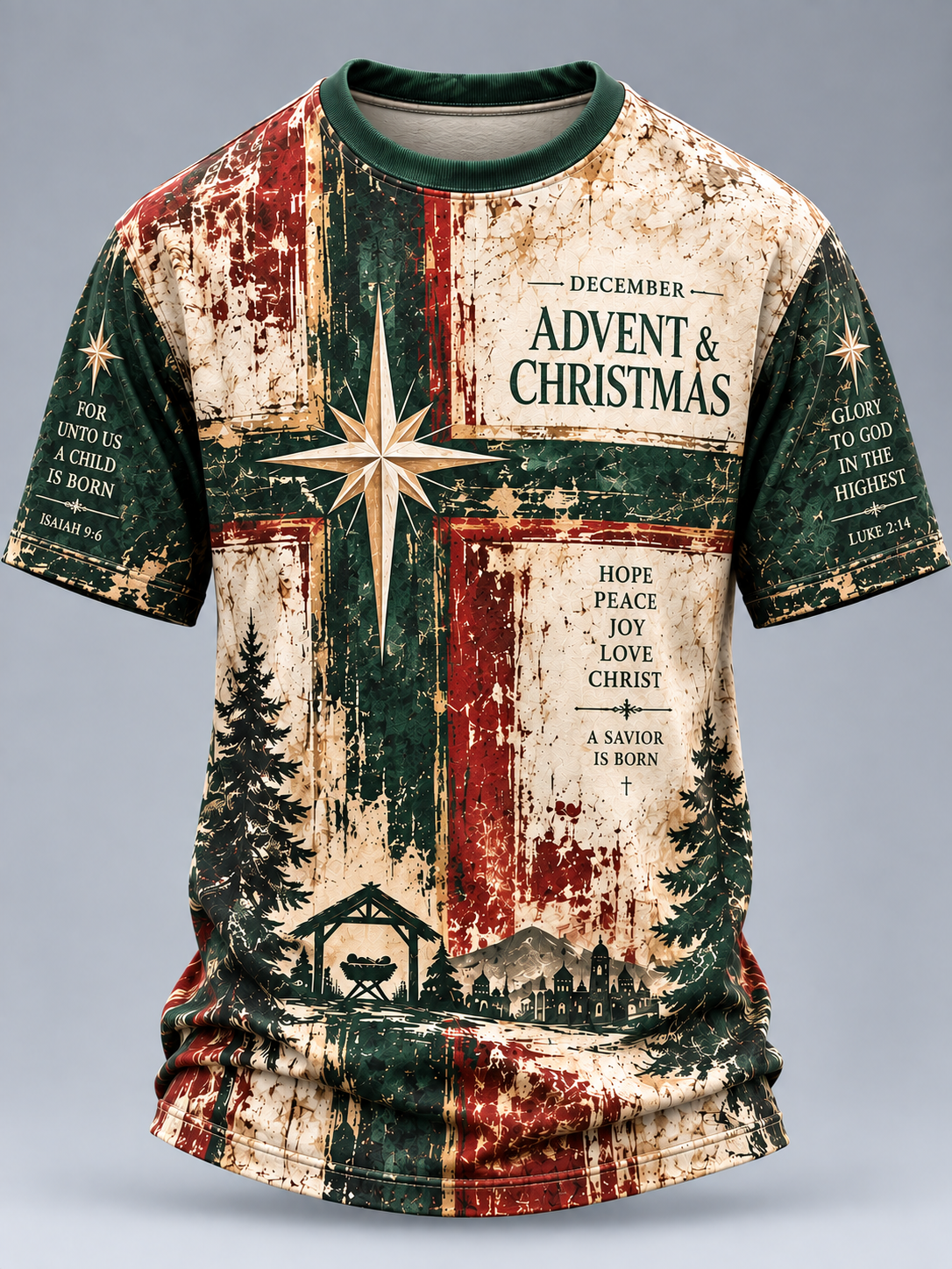 A short-sleeve crewneck t-shirt featuring a distressed, vintage-style Advent and Christmas graphic. The design has a vertical split background of dark green and cream/beige, overlaid with a large white star, a green cross, Christmas trees, a small stable, and various Bible verses printed in black text.