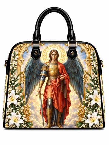 A structured black handbag with dual top handles, featuring a large printed religious artwork of a winged angel in gold armor and red robes, surrounded by white lilies and gold decorative motifs on a white background.