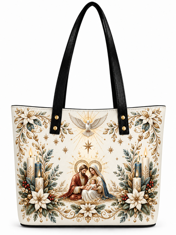 A structured tote bag with black faux-leather shoulder straps and a detailed Christmas-themed print on a cream background. The print features a central religious scene of the Holy Family, flanked by candles, gold stars, and floral wreaths.
