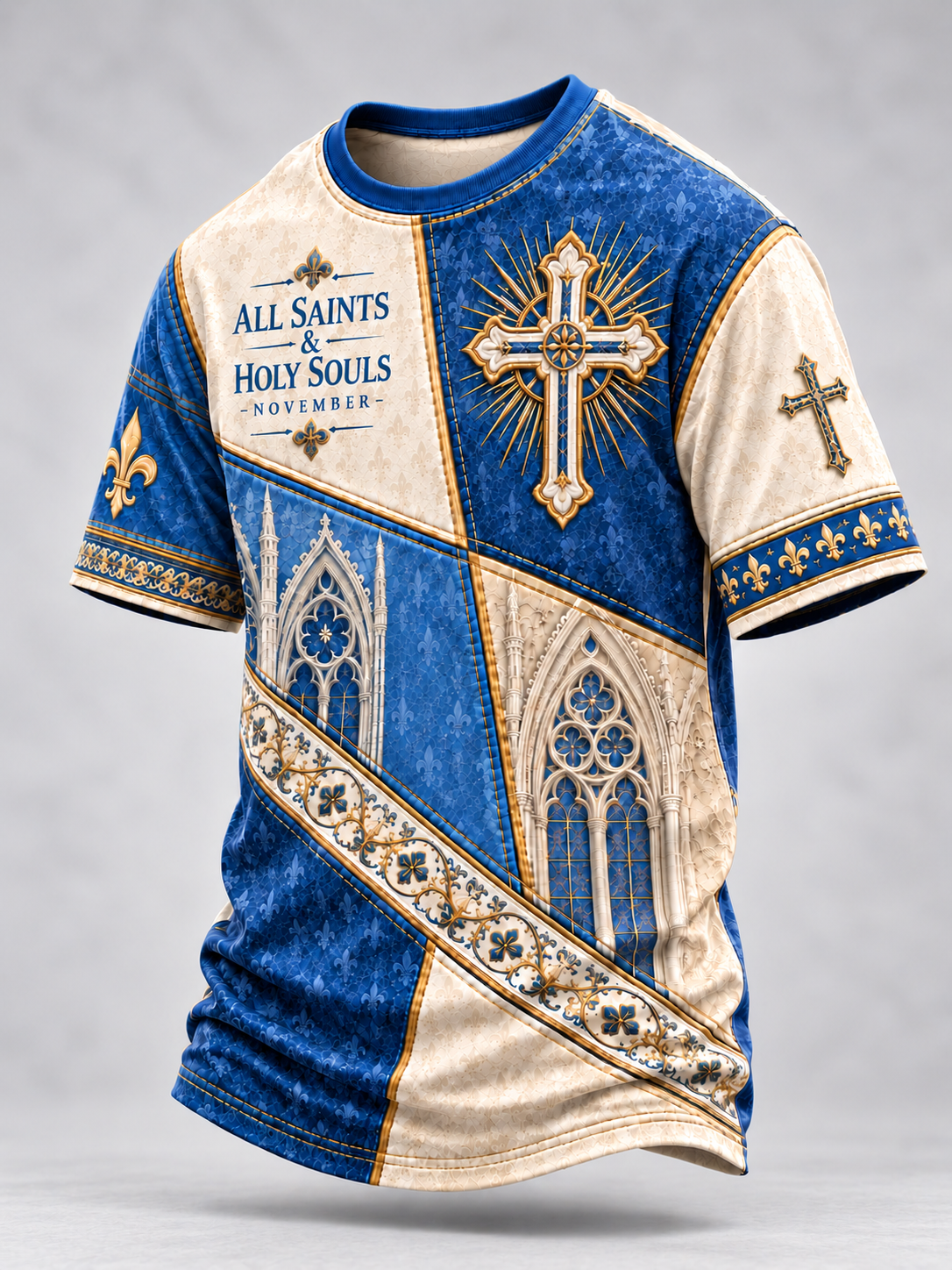 A short-sleeve t-shirt with a detailed religious graphic design in blue and cream, featuring a large gold and blue cross, gothic cathedral windows, fleur-de-lis, and the text 'ALL SAINTS & HOLY SOULS - NOVEMBER -' on the chest.