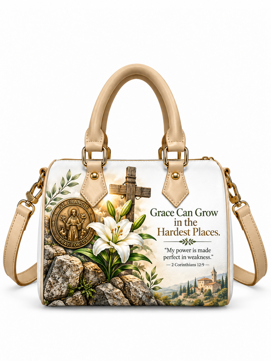 A structured handbag with cream-colored leather handles and strap, featuring a printed design of a white lily, a bronze-toned religious medallion, a wooden cross, and a scenic landscape. The bag has a white background with printed text that reads 'Grace Can Grow in the Hardest Places.
