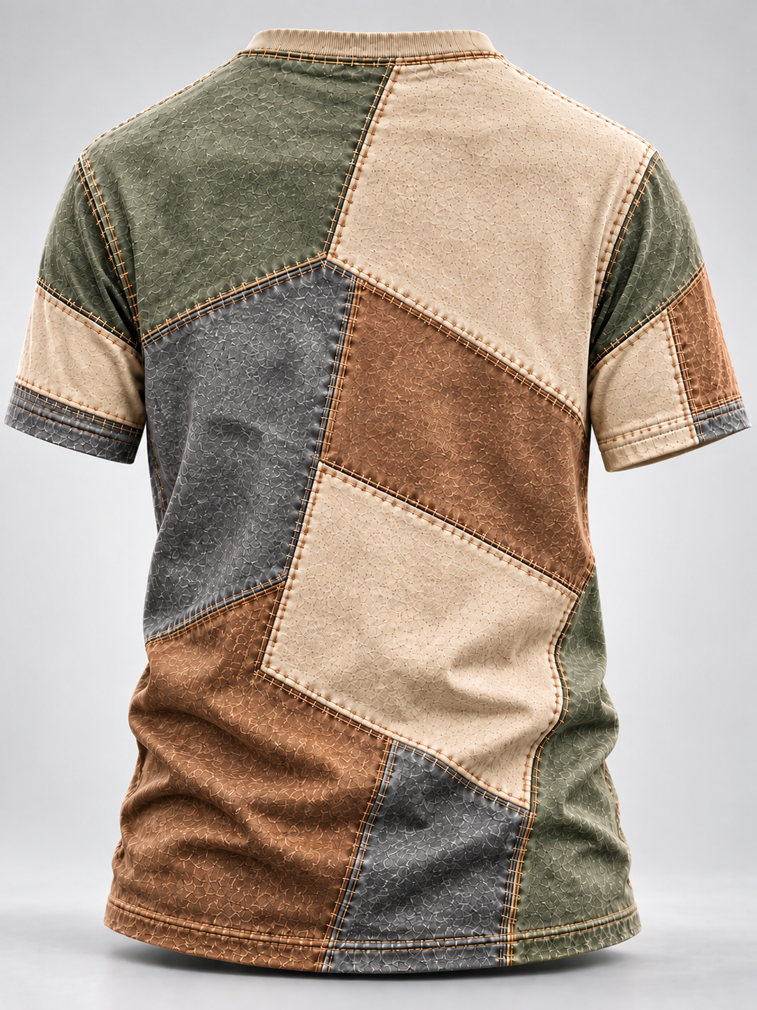 A short-sleeve patchwork t-shirt with a distressed denim wash, featuring geometric panels of olive green, beige, brown, and dark gray on a light gray background.
