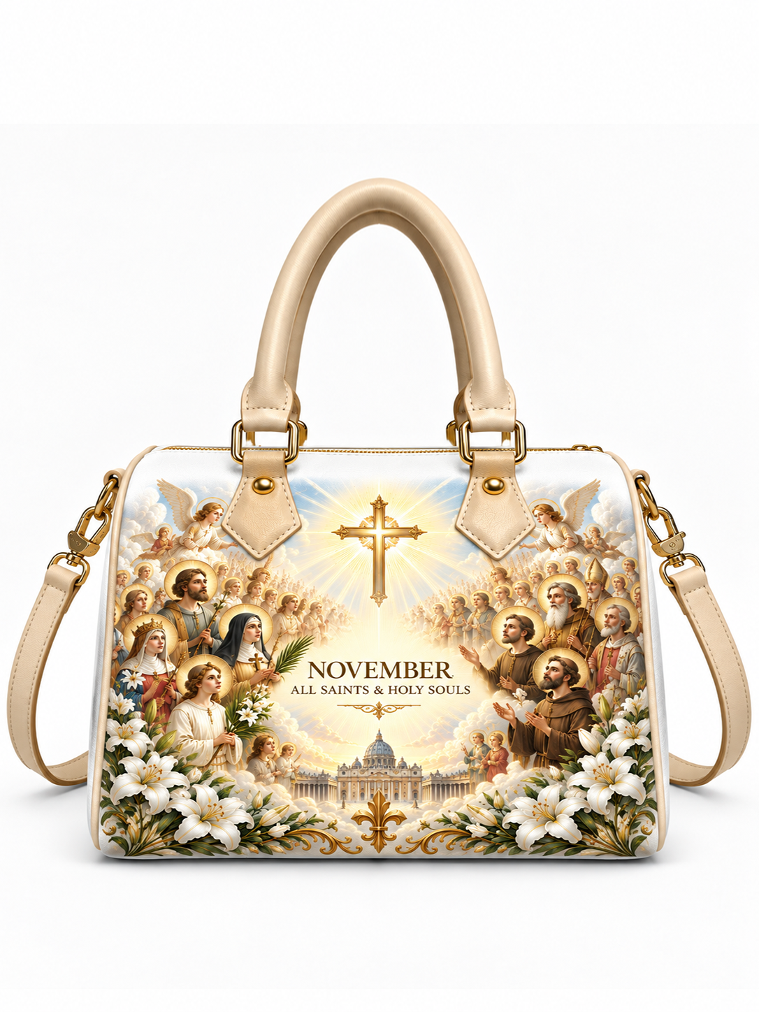 A structured cream-colored handbag with a large religious illustration printed on the front, featuring saints, angels, a radiant cross, white lilies, and the text 'NOVEMBER ALL SAINTS & HOLY SOULS.' The bag has double top handles, gold-tone hardware, and a detachable shoulder strap, shown on a clean white background.