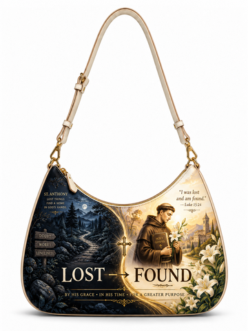 A hobo-style shoulder bag with a cream-colored strap and trim, featuring a split graphic design on the front. The left side depicts a dark, desolate path at night with a moonlit sky and the words 'LOST', while the right side shows a saint holding flowers in a bright town square with the words 'FOUND'.