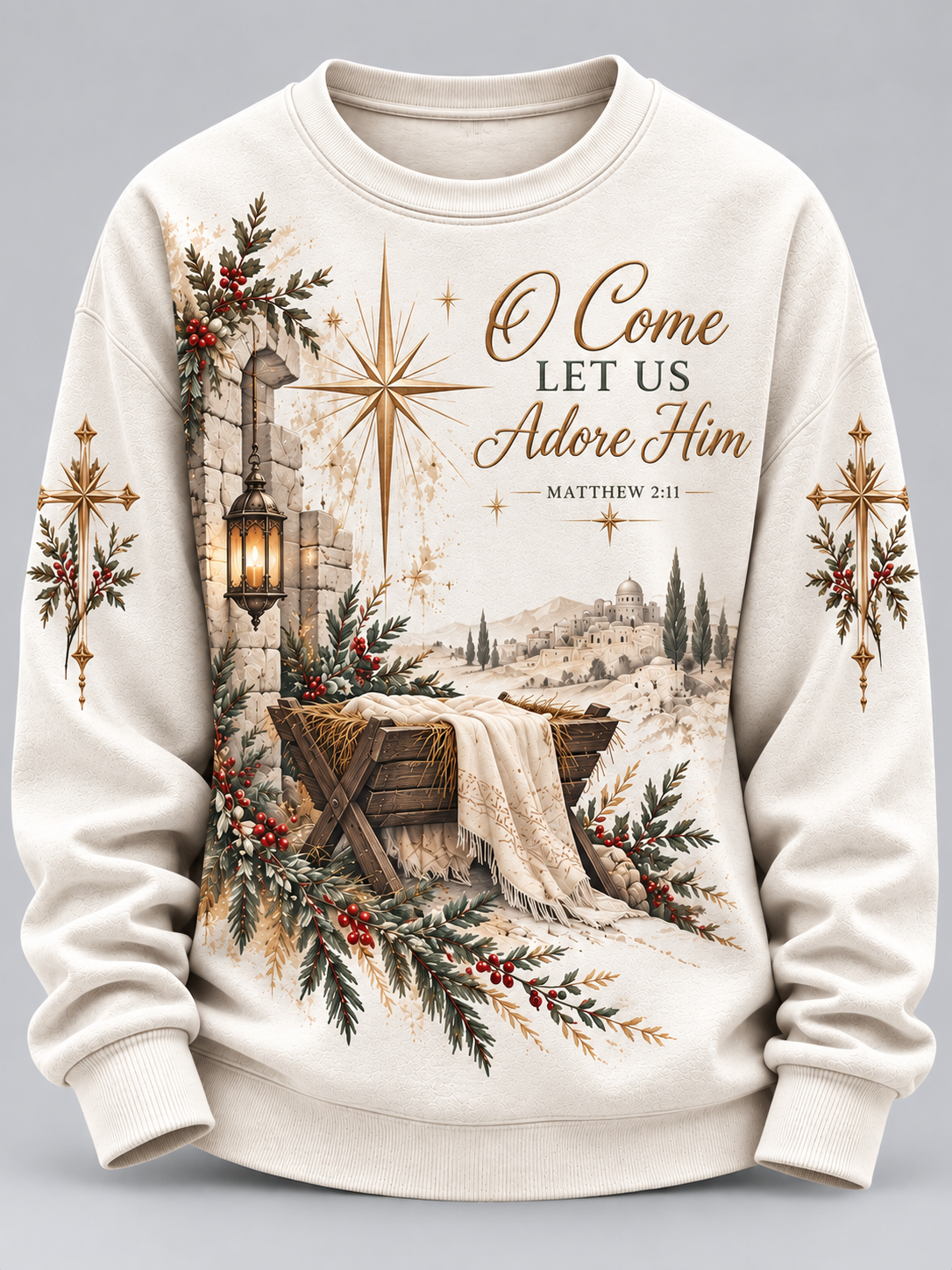 An off-white crewneck sweatshirt featuring a detailed Christmas-themed graphic print with a nativity scene, gold stars, crosses, and the text 'O Come Let Us Adore Him - Matthew 2:11'.
