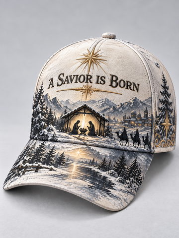 A baseball cap featuring a detailed Christmas nativity scene print with the text 'A SAVIOR IS BORN' on the front, set against a neutral gray background.
