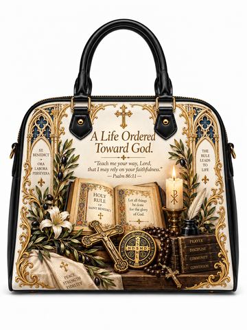 A structured black and gold handbag with a detailed religious illustration featuring Bible verses, holy books, a cross, candles, and rosary beads on the front panel.