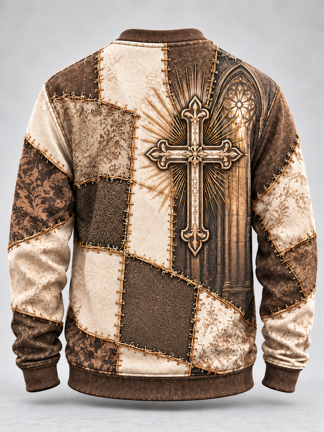 A long-sleeve crewneck sweatshirt shown from the back, featuring a patchwork design in shades of brown and beige with a large ornate cross, sunburst rays, and a gothic cathedral window graphic.