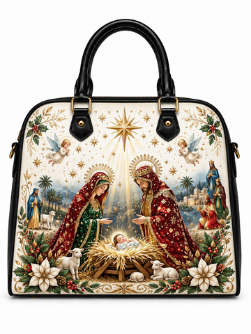 A structured black leather handbag with a large, detailed Christmas Nativity print on the front. The print features Mary, Joseph, baby Jesus in a golden manger, angels, stars, and shepherds.