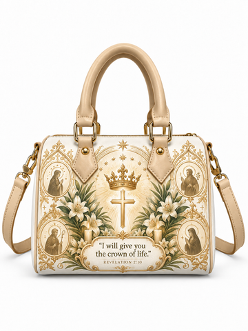A structured handbag with beige handles and a matching shoulder strap, decorated with a religious design featuring a central gold cross, a crown, white lilies, saint portraits, and the Bible verse 'I will give you the crown of life' from Revelation 2:10.