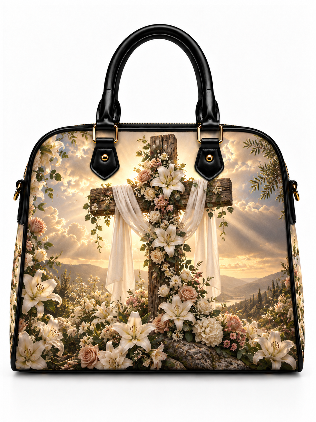 A structured handbag with black leather handles and trim, featuring a detailed print of a floral cross in a scenic landscape with mountains and golden clouds.