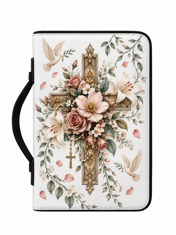 A white Bible or prayer journal with a black handle, decorated with a large central gold cross surrounded by pink and white flowers, green leaves, and two white doves, shown on a plain white background.