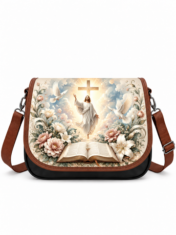 A messenger bag with a brown leather strap and black base, featuring a large front print of a religious scene with Jesus, doves, flowers, and an open book.