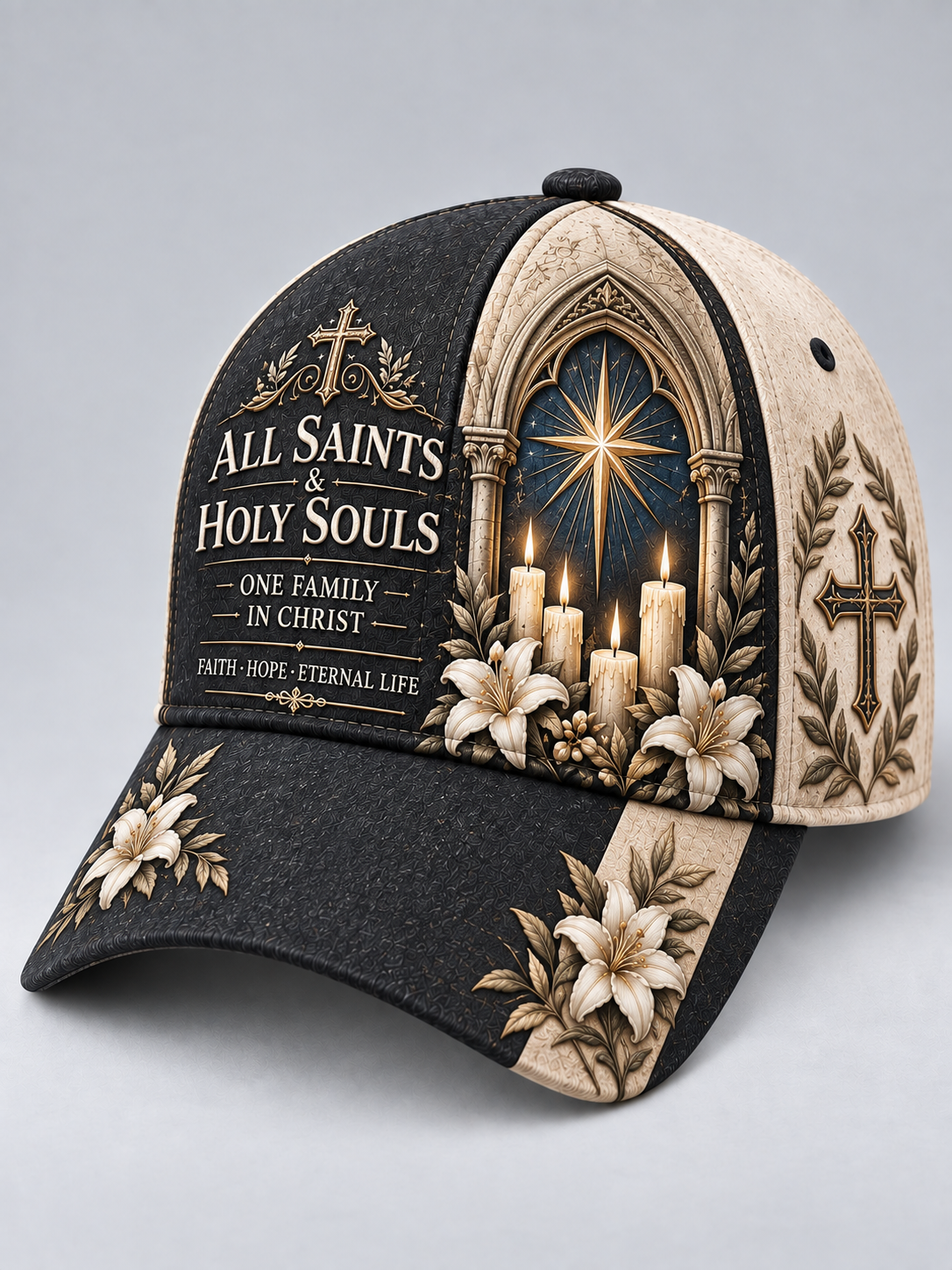 A baseball cap with a split black and beige design, featuring religious graphics including a star in a gothic window, lit candles, lilies, and the text 'ALL SAINTS & HOLY SOULS' and 'ONE FAMILY IN CHRIST'.